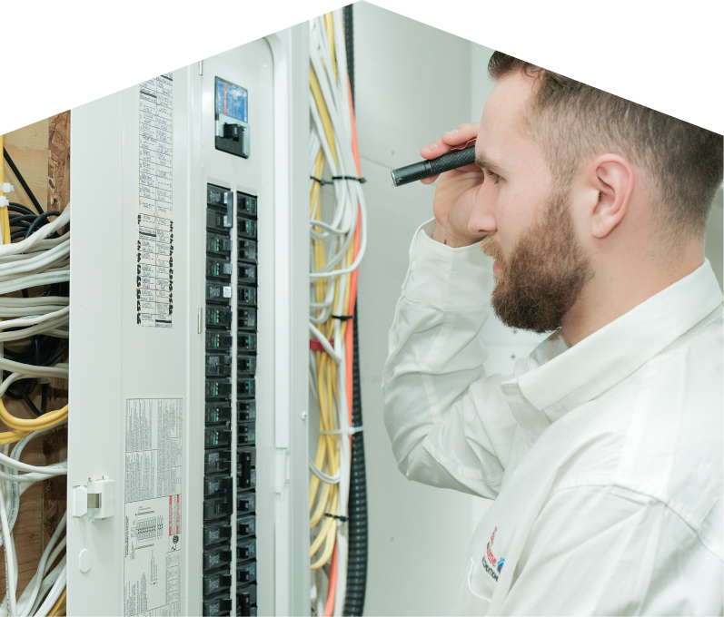 Furnace Guys electrician inspecting residential electrical panel wiring with a flashlight, checking connections and circuit labels. Furnace Guys electrician inspecting residential electrical panel wiring with a flashlight, checking connections and circuit labels.